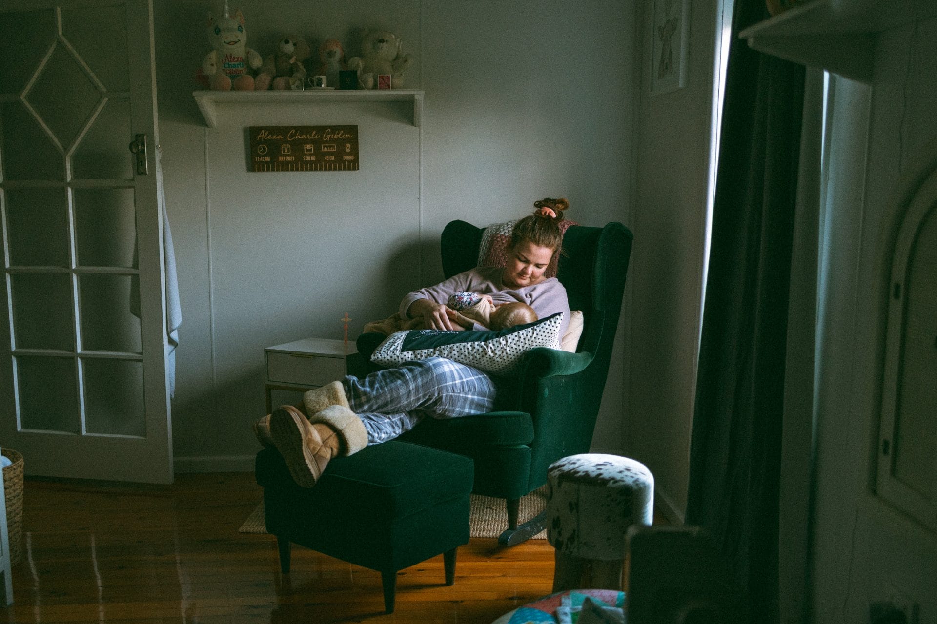 A woman relaxes in a cozy armchair, reading a book in a tranquil room with soft lighting and plush decor.